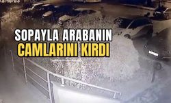 Elindeki sopayla park halindeki otomobilin camını kırdı