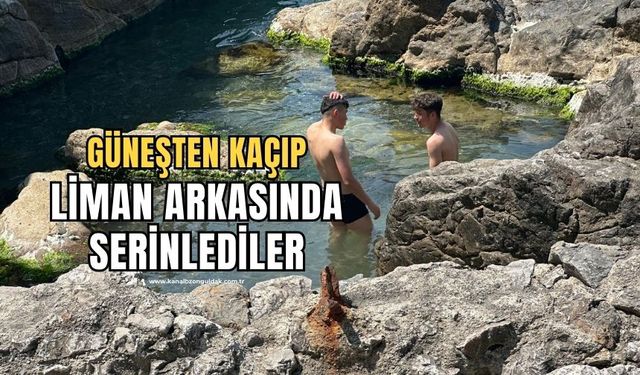 Güneşten korunmak isteyenler liman arkasında denize girdi