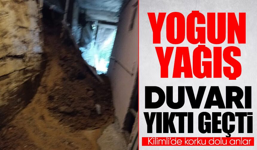 Kilimli’de yoğun yağışla birlikte duvar yıkıldı, toprak binayı doldurdu!